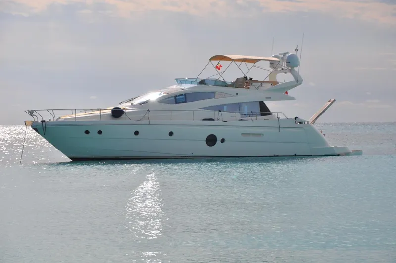 The Image of Luxurious 2010 Aicon 58 yacht anchored on serene waters under a clear sky. - 0