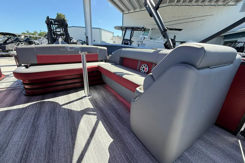 Slide: The Image of 2020 Bennington SXP 25 SSBXP pontoon boat interior with red and gray seating. - 23
