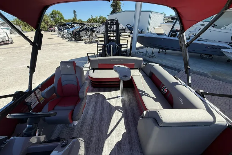 Slide: The Image of 2020 Bennington SXP 25 SSBXP pontoon boat interior with red and gray seating. - 21