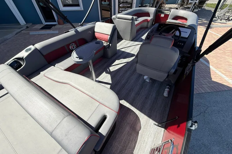 Slide: The Image of 2020 Bennington SXP 25 SSBXP pontoon boat interior with gray seating and steering console. - 14