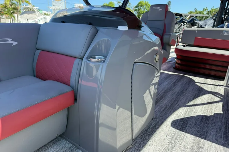 Slide: The Image of 2020 Bennington SXP 25 SSBXP pontoon boat interior with gray and red seating. - 34