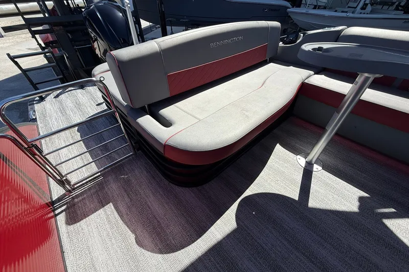 Slide: The Image of 2020 Bennington SXP 25 SSBXP boat interior with cushioned seating and table. - 15
