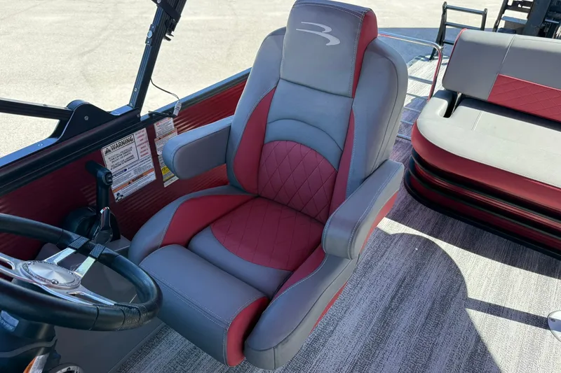 Slide: The Image of Captain's chair on 2020 Bennington SXP 25 SSBXP pontoon boat, red and gray upholstery. - 24