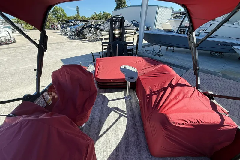 Slide: The Image of 2020 Bennington SXP 25 SSBXP pontoon boat with red covered seating and canopy. - 22