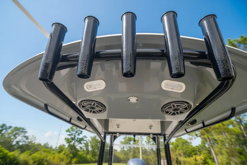 Slide: The Image of 2021 Cobia 280 Center Console boat with rod holders and speakers under the T-top. - 17