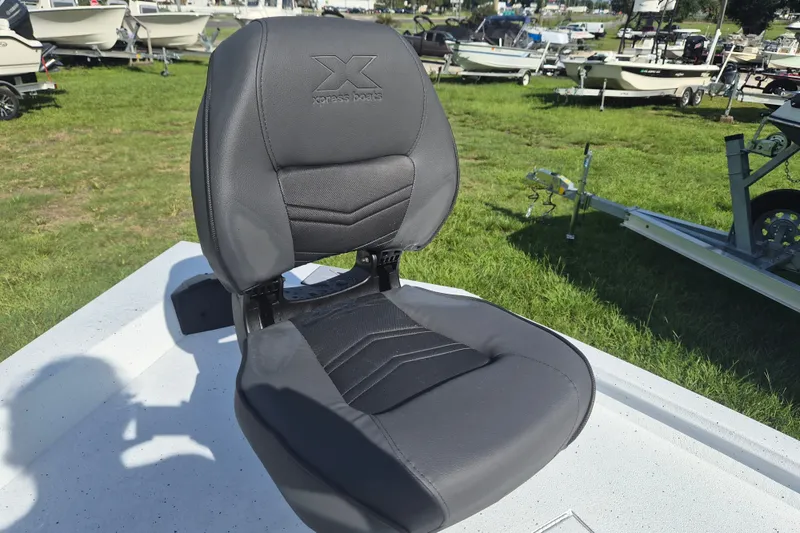 Slide: The Image of 2027 Xpress H20 Bay boat seat on display, surrounded by various boats on grass. - 22