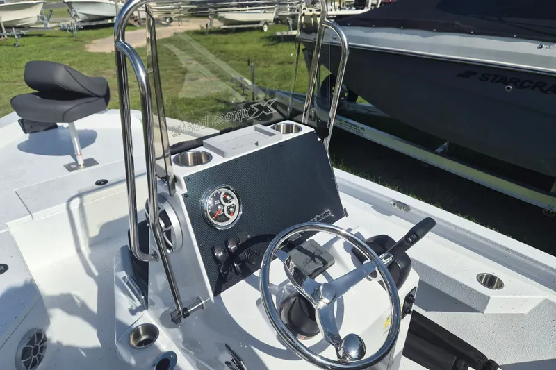 Slide: The Image of 2027 Xpress H20 Bay boat interior with steering wheel and control panel. - 10