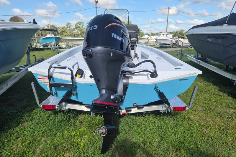 Slide: The Image of 2027 Xpress H20 Bay boat with Yamaha 115 engine on trailer, parked outdoors. - 3