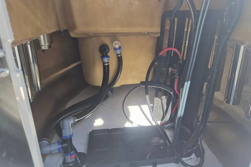 Slide: The Image of Interior view of 2027 Xpress H20 Bay boat showing wiring and plumbing components. - 16