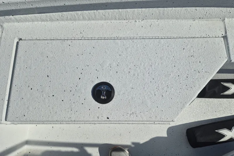 Slide: The Image of 2027 Xpress H20 Bay boat deck with textured surface and latch. - 23