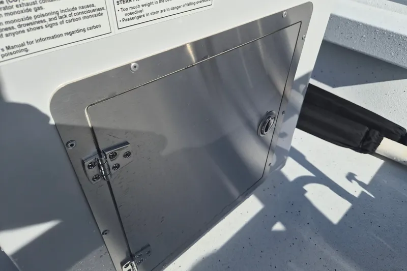 Slide: The Image of Stainless steel hatch on 2027 Xpress H20 Bay boat, featuring safety instructions. - 15