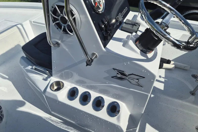 Slide: The Image of 2027 Xpress H20 Bay boat console with steering wheel and control panel. - 17