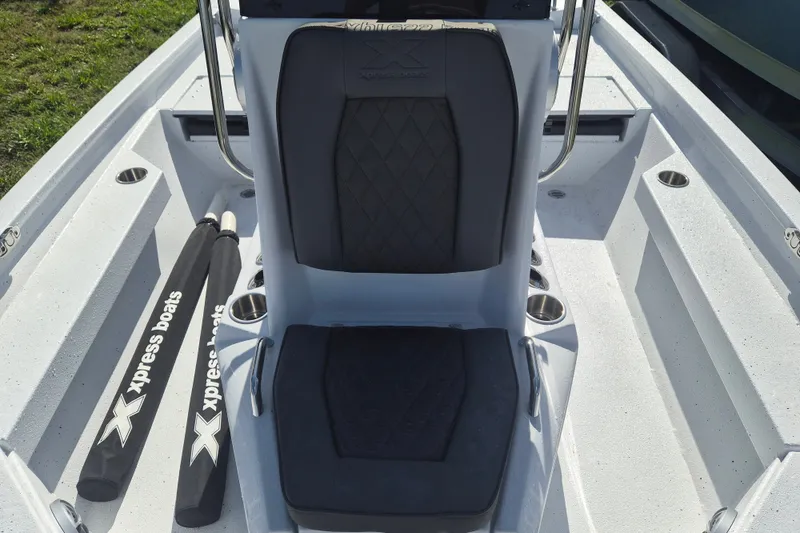 Slide: The Image of 2027 Xpress H20 Bay boat interior with cushioned seating and branded accessories. - 12