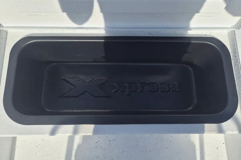 Slide: The Image of Xpress H20 Bay 2027 boat storage compartment with embossed logo. - 26