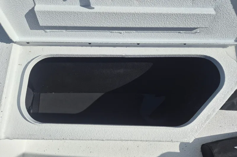 Slide: The Image of Open storage compartment on 2027 Xpress H20 Bay boat. - 24
