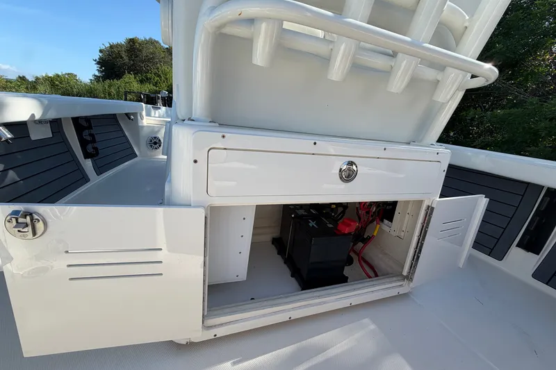 Slide: The Image of 2025 Pathfinder 2400 TRS boat storage compartment with battery and wiring. - 20