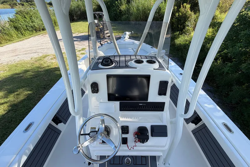 Slide: The Image of 2025 Pathfinder 2400 TRS boat console with steering wheel and navigation equipment. - 15