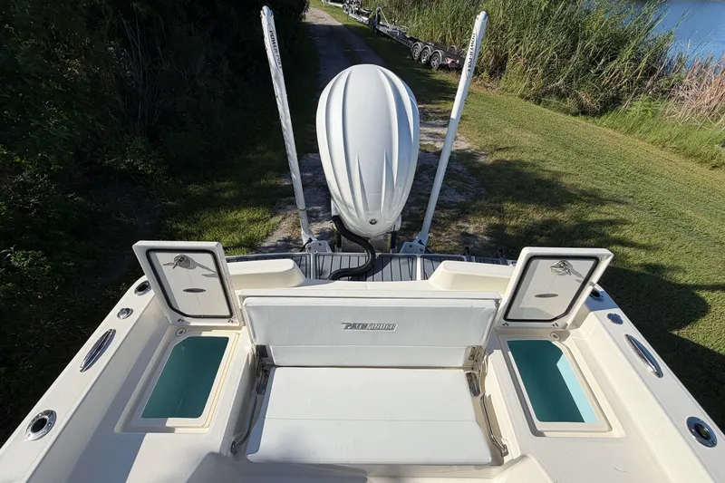 Slide: The Image of 2025 Pathfinder 2400 TRS boat with open storage compartments, viewed from the rear. - 16