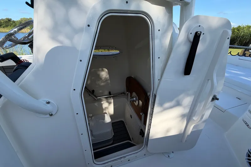 Slide: The Image of 2025 Pathfinder 2400 TRS boat interior with open door, showcasing compact cabin space. - 22