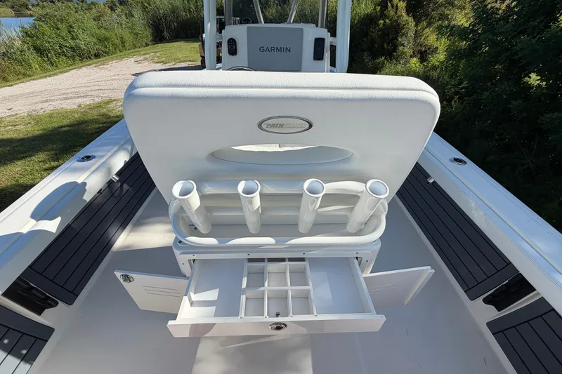 Slide: The Image of 2025 Pathfinder 2400 TRS boat interior with rod holders and storage compartments. - 21