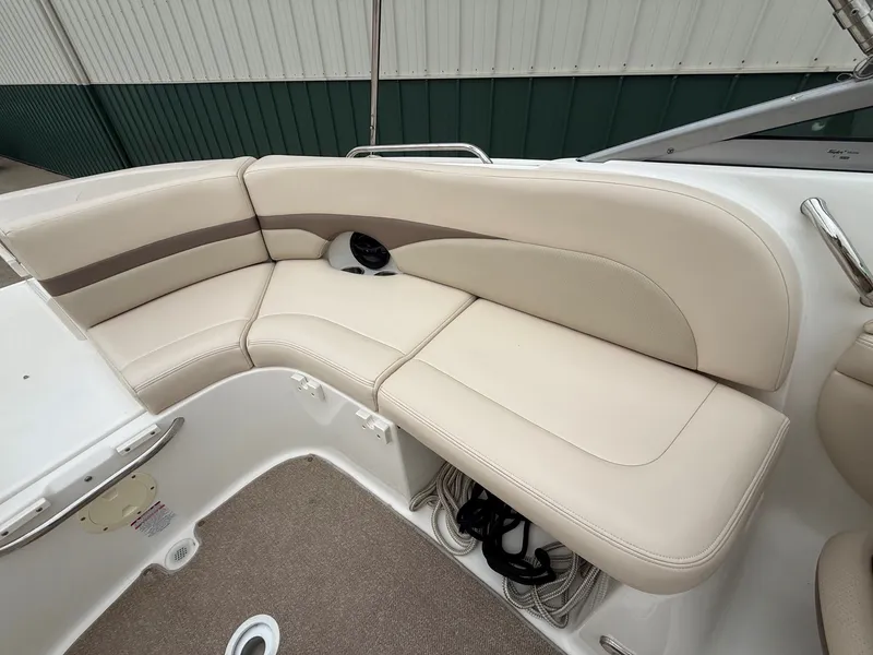 Slide: The Image of The image shows the seating area of a 2006 Chaparral SSi 256 with beige upholstery. - 24