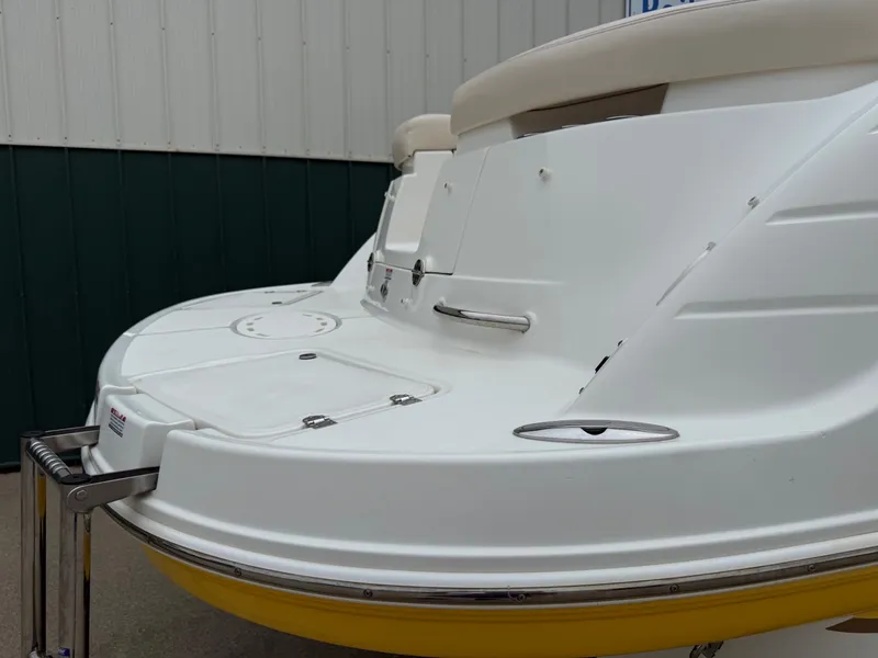 Slide: The Image of The image shows the stern of a 2006 Chaparral SSi 256 boat with a yellow underside. - 8