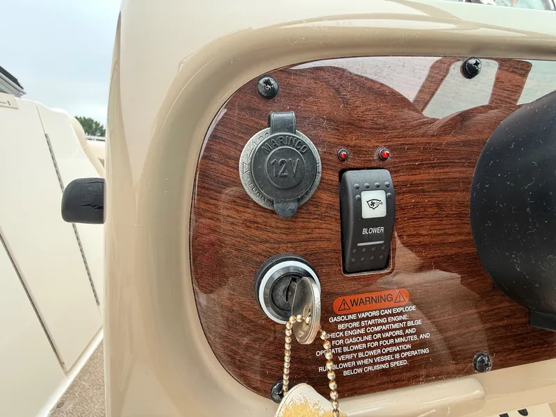 Slide: The Image of Close-up of a 2006 Chaparral SSi 256 dashboard with ignition key and warning labels. - 20