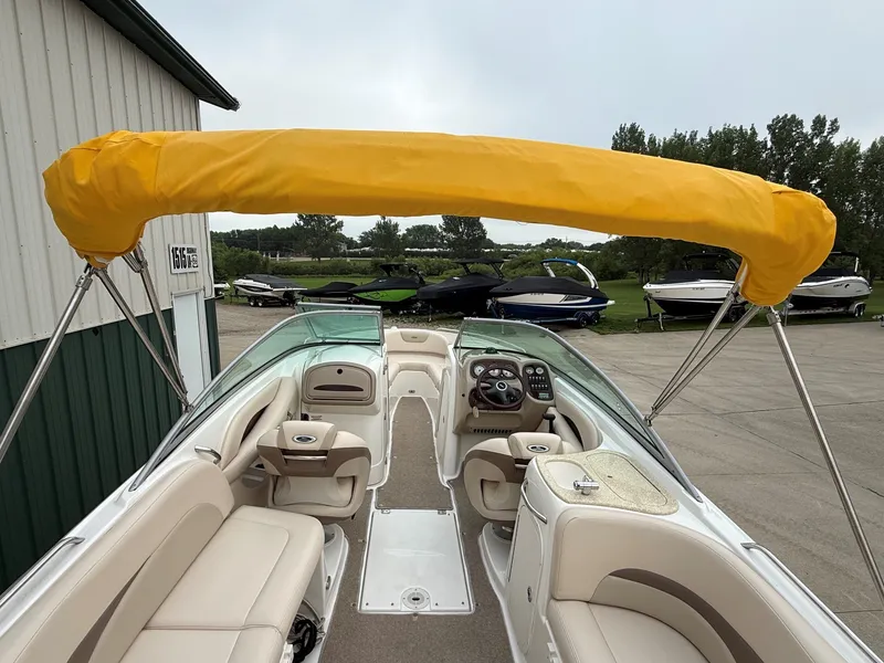 Slide: The Image of The image shows a 2006 Chaparral SSi 256 boat with a yellow sunshade. - 36