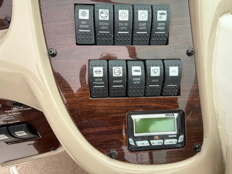 Slide: The Image of Control panel of a 2006 Chaparral SSi 256 with various switches and a JBL marine radio. - 18