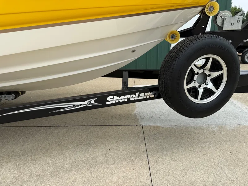 Slide: The Image of A yellow boat on a trailer labeled "ShoreLand'r." - 46