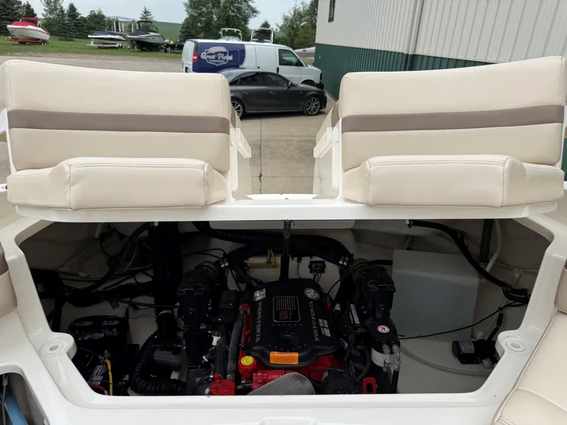 Slide: The Image of The 2006 Chaparral SSi 256 shows its engine compartment with two beige seats in the background. - 41