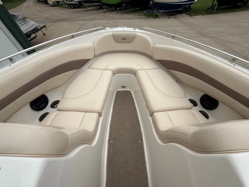 Slide: The Image of The image shows the bow area of a 2006 Chaparral SSi 256 boat with beige upholstery. - 11