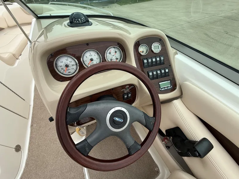 Slide: The Image of The image shows the cockpit of a 2006 Chaparral SSi 256 with a sleek wood steering wheel and dashboard. - 17