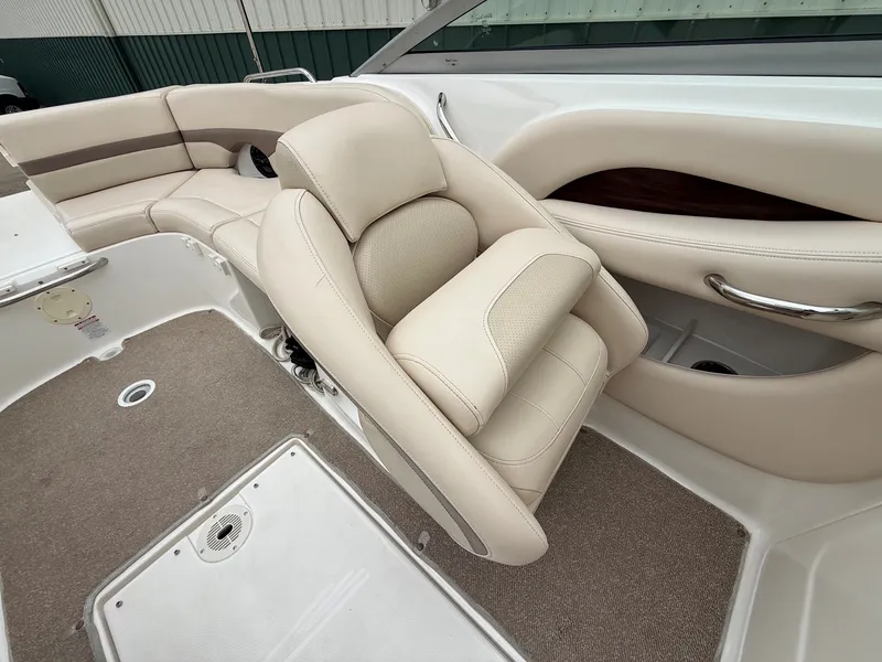 Slide: The Image of The image shows the interior of a 2006 Chaparral SSi 256 boat with beige upholstery. - 23