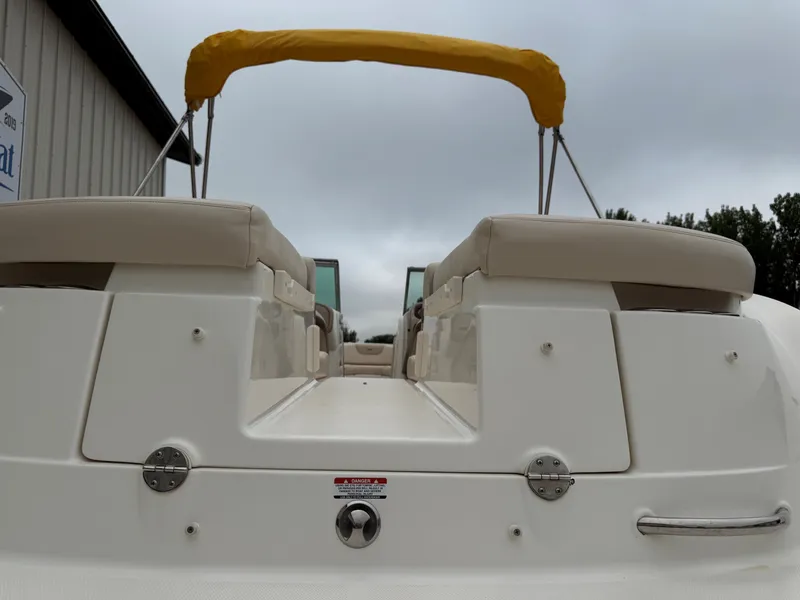 Slide: The Image of The image shows the stern of a 2006 Chaparral SSi 256 boat with a yellow sunshade. - 9