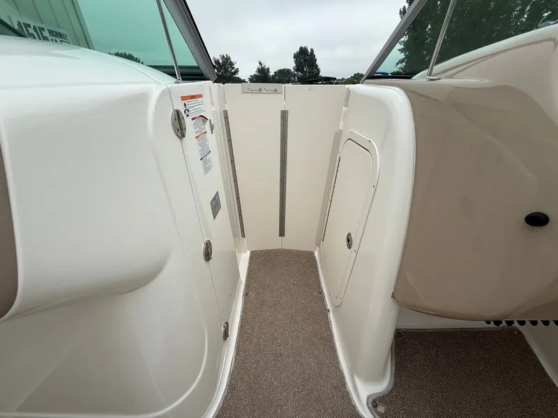 Slide: The Image of The image shows the interior of a 2006 Chaparral SSi 256 boat with beige carpeting. - 15