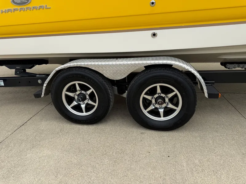 Slide: The Image of Close-up of a boat trailer with two wheels and a yellow boat hull. - 45