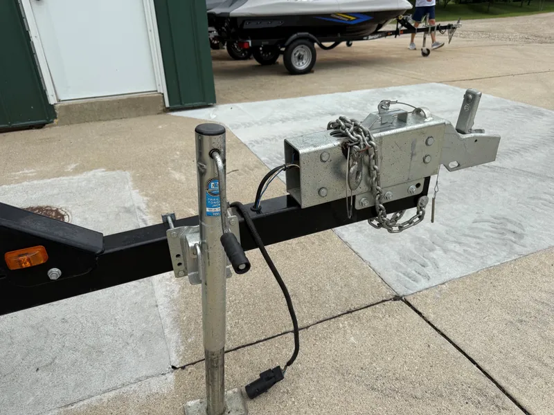 Slide: The Image of A boat trailer with a hitch and chain, ready for transporting a boat. - 47