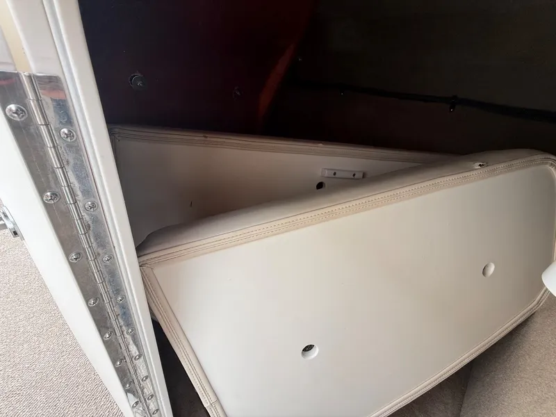 Slide: The Image of Interior of a 2006 Chaparral SSi 256 with white upholstered seating and carpeted flooring. - 14