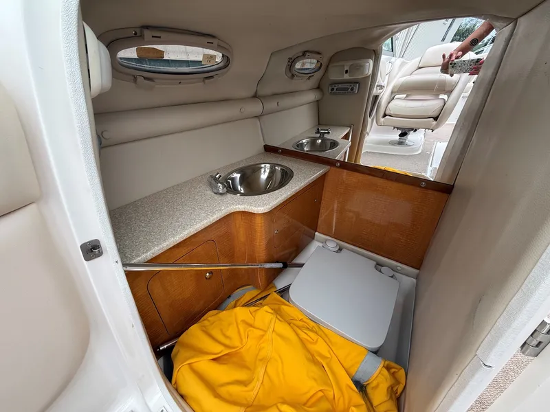 Slide: The Image of Interior of a 2006 Chaparral SSi 256 with sink, storage, and a yellow jacket. - 21