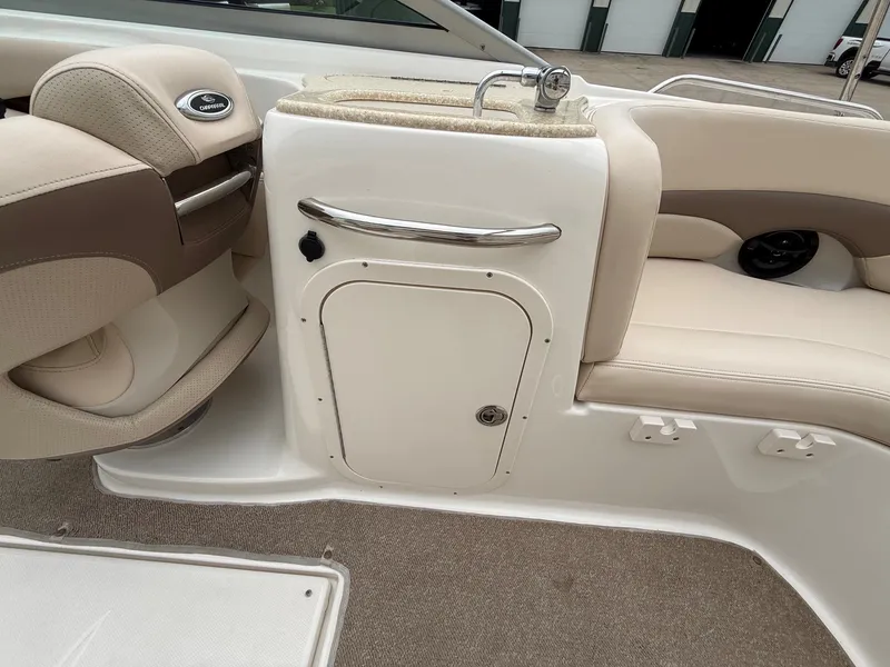 Slide: The Image of Interior of a 2006 Chaparral SSi 256 with beige upholstery and a small sink. - 27