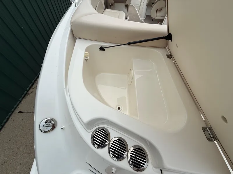Slide: The Image of The image shows the interior of a 2006 Chaparral SSi 256 with an open storage compartment. - 31