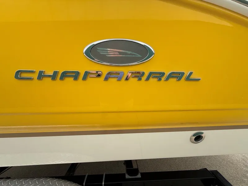 Slide: The Image of Close-up of a yellow Chaparral SSi 256 boat hull with the brand name visible. - 5