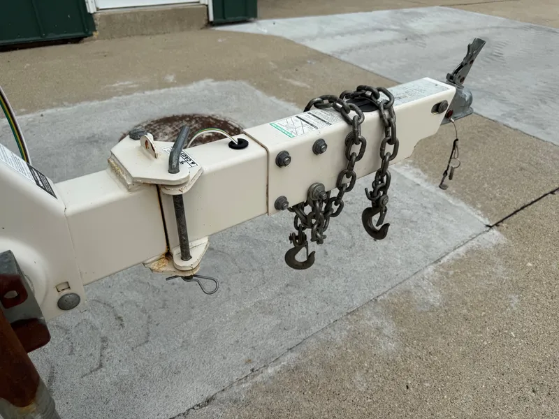 Slide: The Image of Close-up of a boat trailer hitch with chains on a concrete surface. - 23