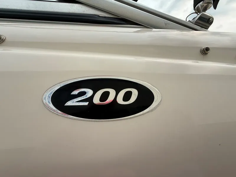 Slide: The Image of Close-up of the Sea Ray 200 Sport emblem on a white boat hull. - 5