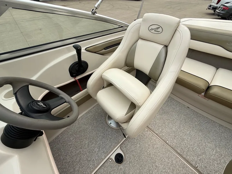 Slide: The Image of Interior of a 2005 Sea Ray 200 Sport with beige steering wheel and seat. - 13