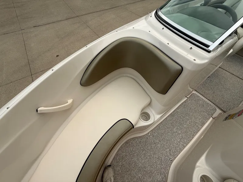 Slide: The Image of The image shows the seating area of a 2005 Sea Ray 200 Sport boat with cushioned seats. - 10