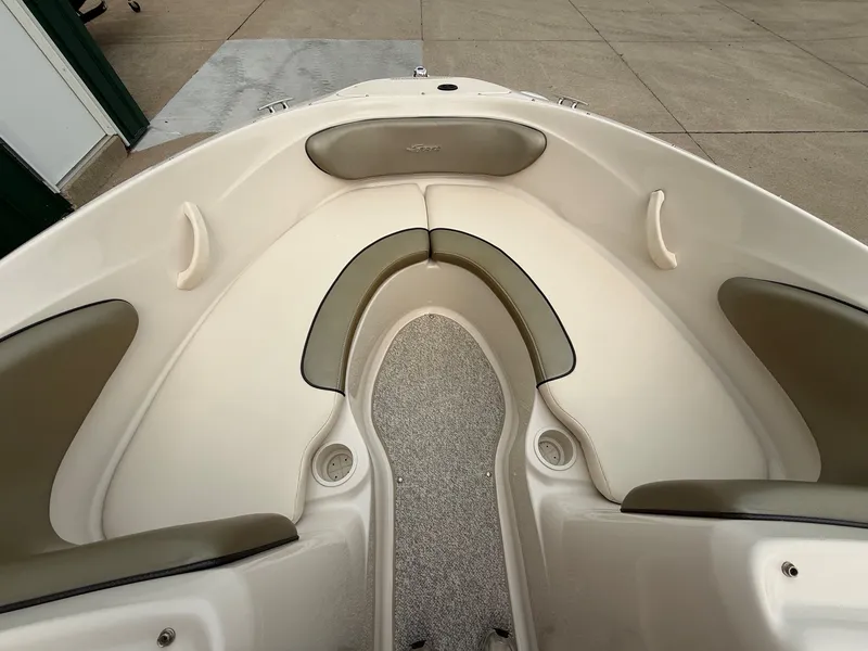 Slide: The Image of The image shows the bow area of a 2005 Sea Ray 200 Sport boat with cushioned seating. - 9