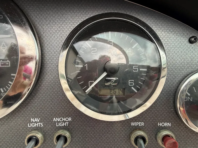 Slide: The Image of Tachometer and switches on a 2005 Sea Ray 200 Sport boat. - 16