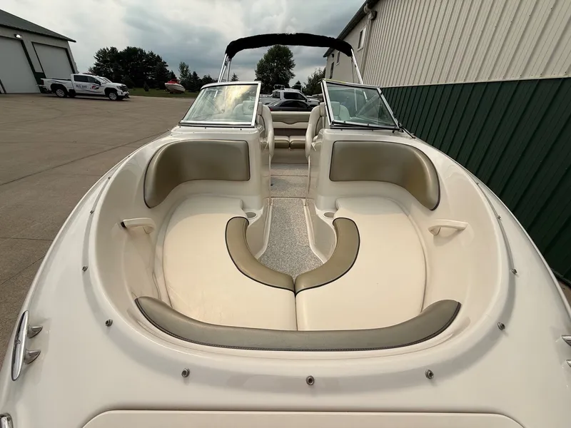 Slide: The Image of The image shows the cockpit of a 2005 Sea Ray 200 Sport boat with beige seating. - 3